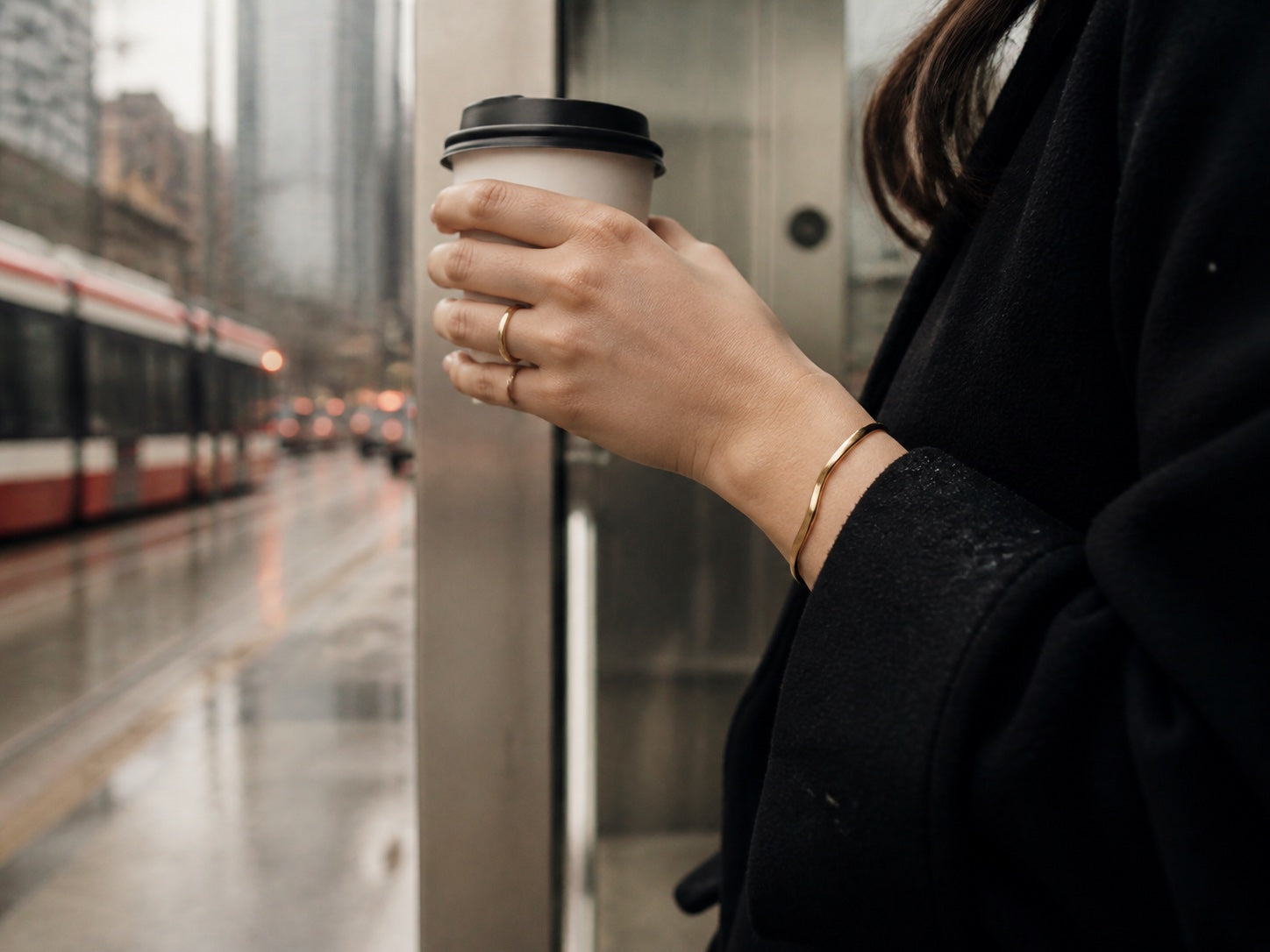 Gold ring and bracelet worn while waiting beside a Toronto streetcar