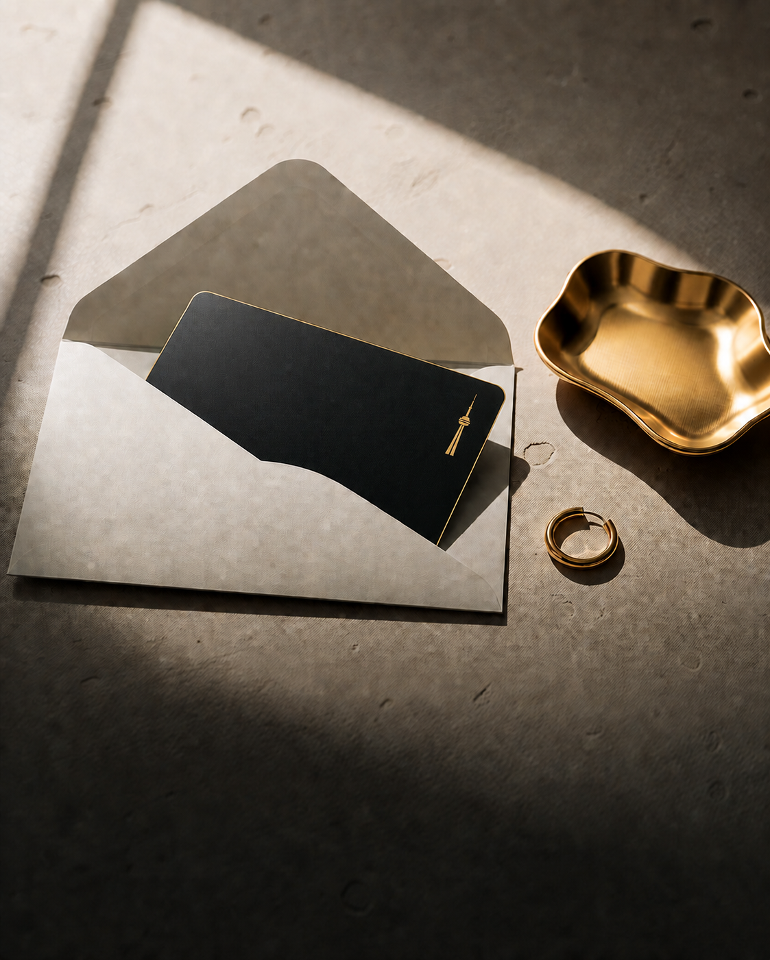 Black Labelle gift card with a gold Toronto tower mark in a cream envelope